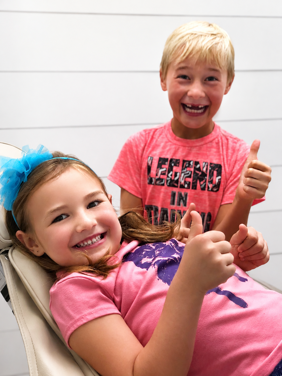 Two smiling kids giving thumbs up in the dental chair at Boesch Dental